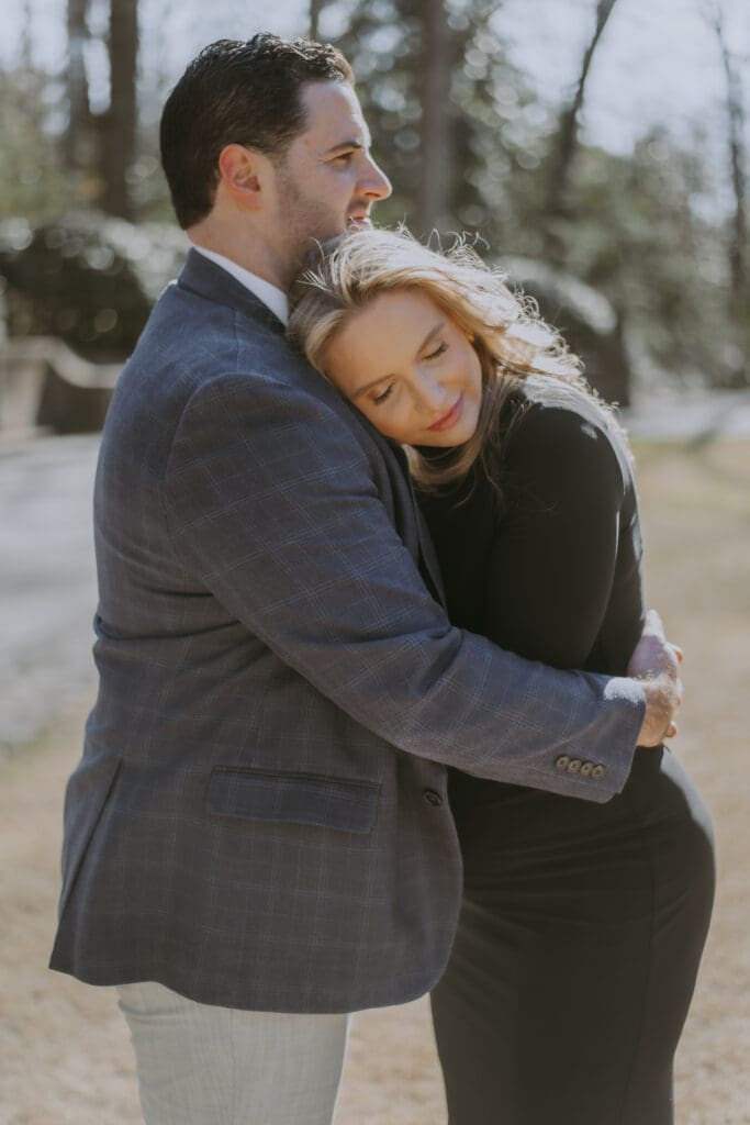 husband wife embracing during maternity session at the swan house by kattie jackson photography 