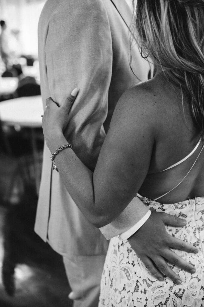 Documentary based moment of husband and wife welcoming guests at intimate wedding in black and white. by georgia wedding photographer kattie jackson 